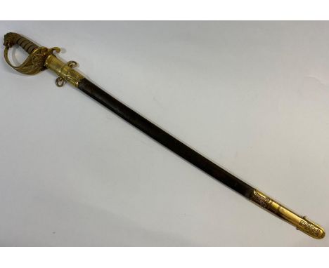 A NAVAL OFFICERS SWORD AND SCABBARD. A Naval Officers sword with a slightly curved 73cm pointed, single edged and fullerd bla