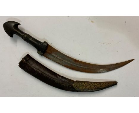 A KINDJAHL TYPE KNIFE AND SCABBARD. A knife with a 25cm curved double sided blade with central rib on a black horn handle wit