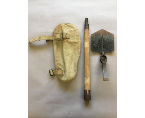 A SECOND WORLD WAR BRITISH ENTRENCHING TOOL. An entrenching tool, the blade stamped with a Government arrow and '1945 Chillin