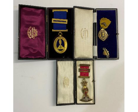 A MASONIC BADGE FOR THE ORDER OF THE ROSE CROIX AND TWO OTHERS. An elaborate silver gilt breast badge with red ribbon and sil