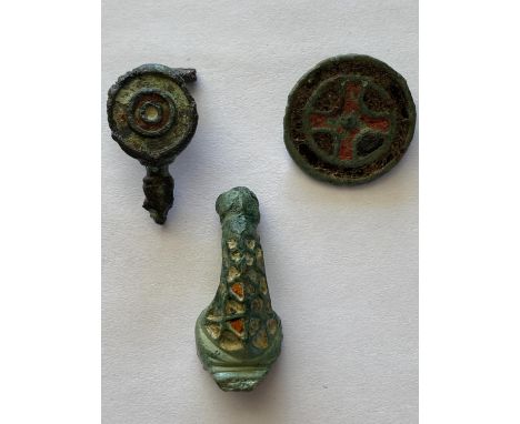 A ROMAN COPPER-ALOY AND ENAMEL BROOCH AND TWO OTHERS. A Roman Copper-Alloy and Enamel Disc Brooch, 2nd-3rd Century A.D. The f