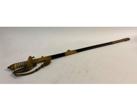 A NAVAL OFFICERS SWORD AND SCABBARD. A mid 20th Century Naval Officers sword with an 80cm blade with partial fuller, unsharpe