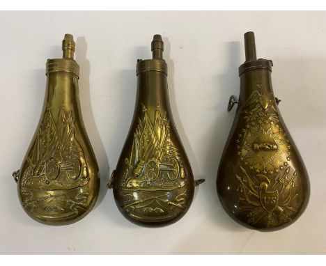 THREE COPPER AND BRASS POWDER FLASKS WITH AMERICAN THEMED DECORATION. A copper powder flask embossed with American flags, arm