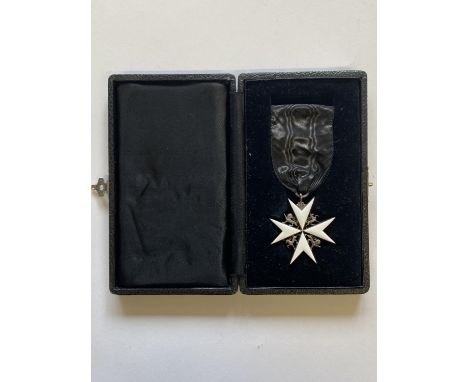 THE ORDER OF ST JOHN. A breast badge for the Order of St John, white enamel eight pointed Maltese star with lions and unicorn