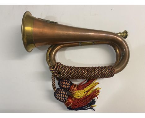 A BRASS AND COPPER BUGLE WITH ONTARIO REGIMENT BADGE. A bugle with Ontario Regiment badge of a cat with arched back within a 