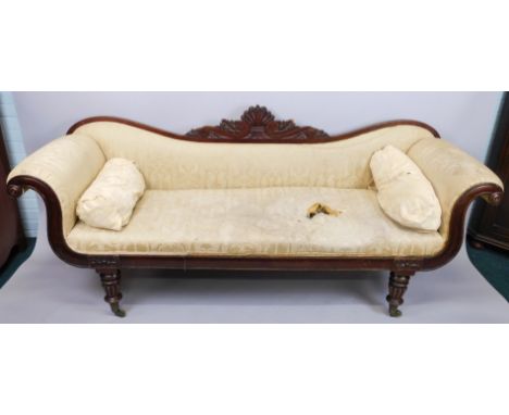 A William IV mahogany sofa, the sofa and back carved with scrolls, flowers, etc, with padded back, arm rests and seat, the ch