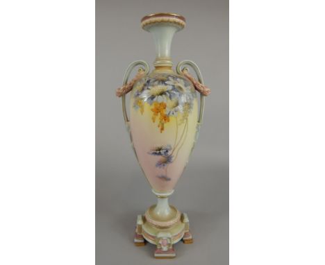 A Royal Worcester two handled ovoid vase, of classical urn shaped design with garland and scroll handles and on four stylised