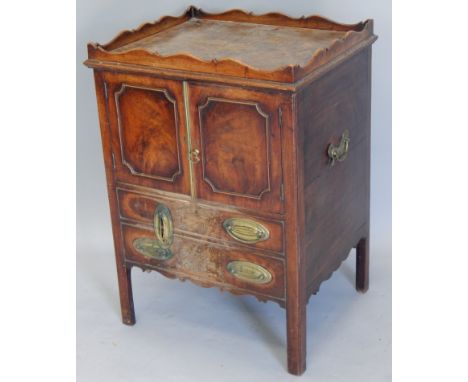 A George III mahogany night commode, with a raised gallery above two panelled doors, enclosing a recess for a chamberpot, abo
