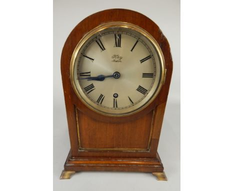 A late 19th/early 20thC mahogany and brass mantel clock, the silvered dial stamped K Maker, with an arched top and brass ogee