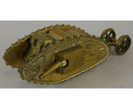 A brass apprentice type model of a First World War tank, mounted to the reverse with carriage wheels, the front with two arti