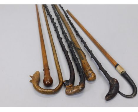 A collection of walking sticks, to include a stick with a carved fox handle, another stick with a chamois horn handle etc. (M