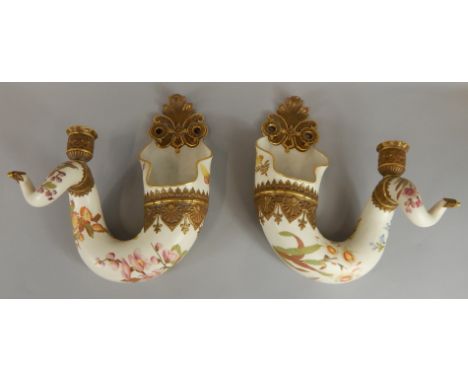 A pair of Royal Worcester twisted cornucopia ivory wall vases, with candle holders, with a raised band of decoration and moul