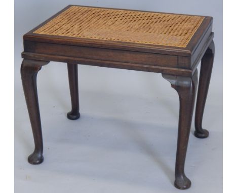 An early to mid 20thC mahogany dressing stool, with a cane seat, on cabriole legs, 56cm wide (M)