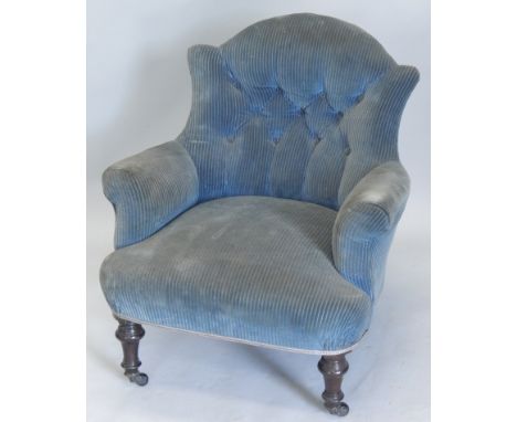 A Victorian ebonised armchair, upholstered in blue striped button fabric, on turned legs with ceramic castors (M)