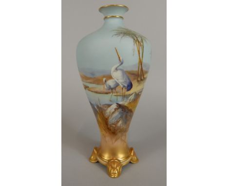 A Royal Worcester slender tapered ovoid vase, painted with two storks at a watering hole in a desert landscape, on a sky blue