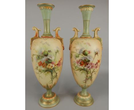 A pair of Royal Worcester two handled ovoid vases, painted with floral sprays, on an ivory ground with pale green necks and s