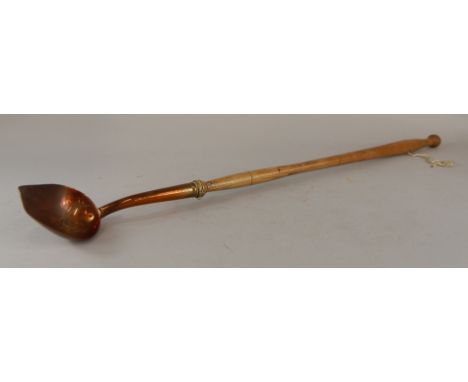An unusual industrial type ladle, with copper bowl and turned ash handle,81cm long (M)