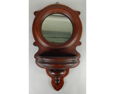 A late 19thC mahogany wall pocket or wall mirror, with a bow fronted receptacle, 67cm x 38cm (M)