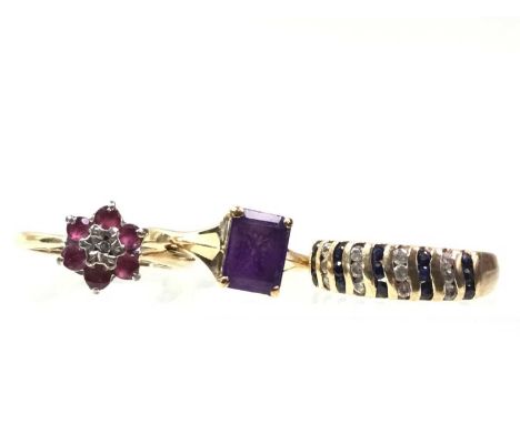 THREE GOLD RINGS, IN NINE CARAT GOLD one set with a diamond chip and ruby coloured stones, the other two with dress stones, e
