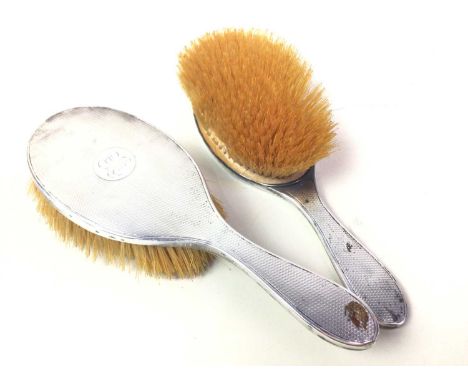 TWO SILVER BRUSHES, each with engine turned decoration and engraved initials