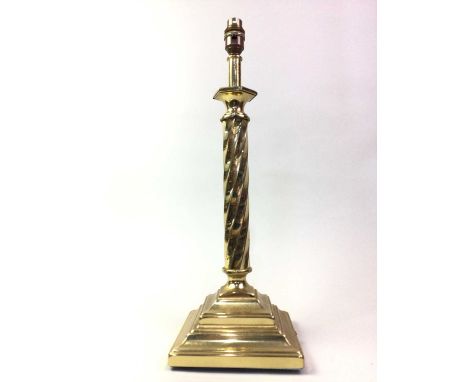 TWO BRASS CANDLESTICKS, one modelled as a barley twist column on a raised stepped base, the other candlestick raised on a ste
