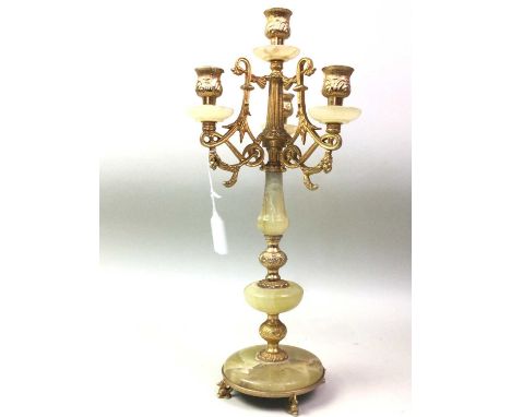 ONYX TABLE SET, C.1970 comprising an onyx and gilt metal candelabrum, cigarette box, table lighter and ashtraythe candelabrum
