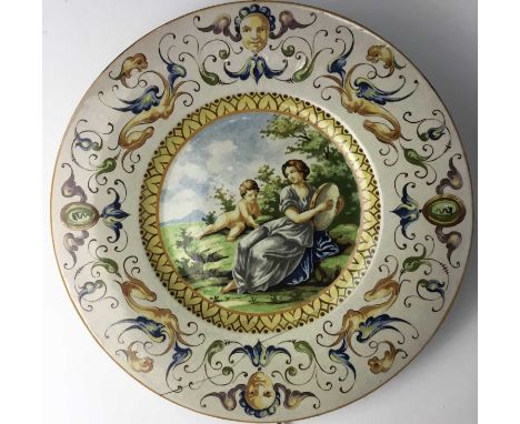 ITALIAN MAJOLICA ISTORIATA DISH, LATE 19TH/EARLY 20TH CENTURY depicting a young lady with tambourine and child, within a bord