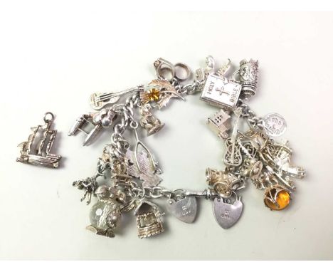 SILVER CHARM BRACELET, with various charms including a holy bible, violin and furtherQty: 108g