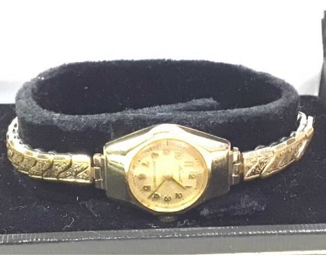 NINE CARAT GOLD CASED MANUAL WIND WRIST WATCH, the dial signed 'Russell', on a gold plated expanding bracelet