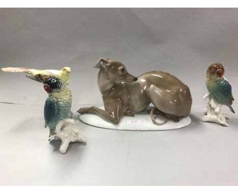 Figure of a recumbent whippet, 29cmL (one toe broken),a Royal Dux figure of a yellow songbird, and two small continental cera