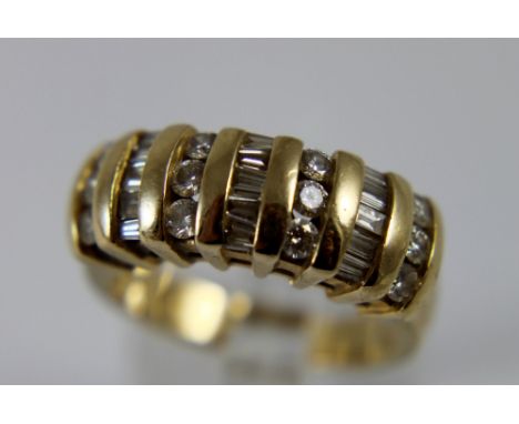 14 K stamped yellow gold ring set with round and baguette cut diamonds