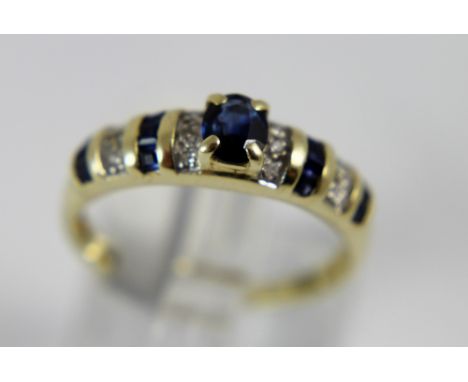 Ladies 14 ct channel set sapphire and diamond ring, size O