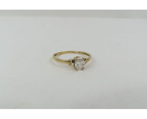 A dress ring set with a single oval colourless stone ring, marked '9ct', finger size M 1/2, 1.1g gross