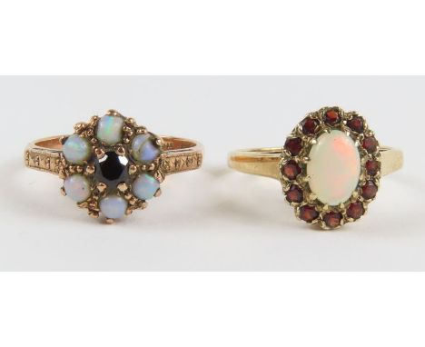 A 9ct gold opal and garnet cluster ring, finger size L 1/2 and a 9ct gold opal and garnet dress ring, finger size M; 4.4g gro