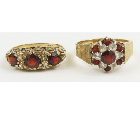 A 9ct gold garnet and clear stone cluster ring, finger size N; and a garnet and clear stone carved head ring, marked '9ct', f