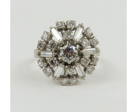 A diamond bombe cluster ring, the central round brilliant cut diamond approximately 4.2mm, surrounded by six baguette cut dia