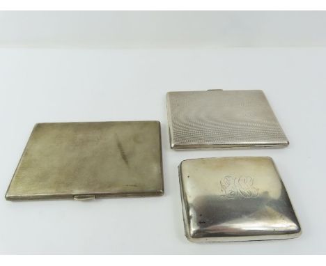Three silver cigarette cases, two of slim rectangular form with engine turned decoration and initials engraved to the cartouc