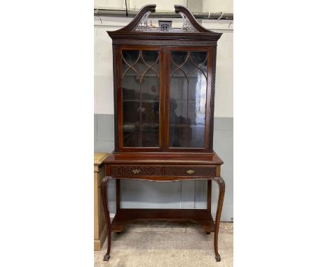 A 20th century mahogany Chippendale style glazed cabinet, with three adjustable shelves, two single short drawers, and standi