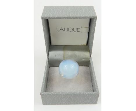 A Lalique opalescent glass domed ring, signed to the outside of the band, finger size K 1/2, boxed 