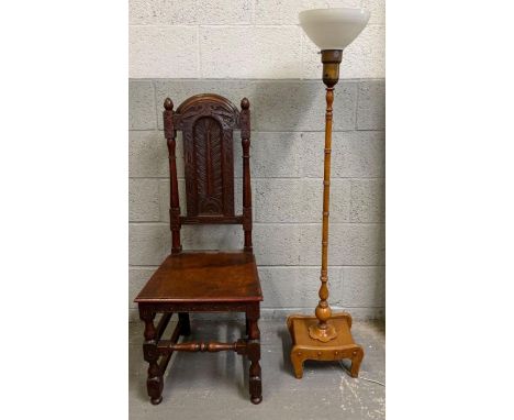 A 19th century oak carved chair, along with a 20th century standard lamp with holophane shade