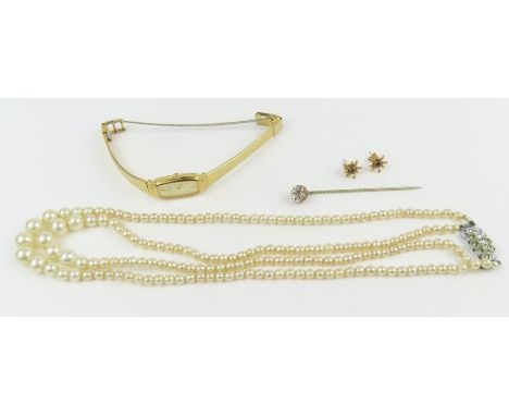 A pair of 9ct gold garnet set stud earrings, 1.2g gross; a simulated pearl necklace, a stick pin and a ladies Seiko watch 