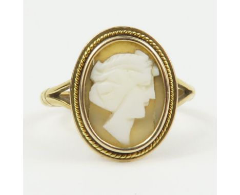 A brown shell cameo ring, marked '9ct', finger size V 1/2, 3.5g gross