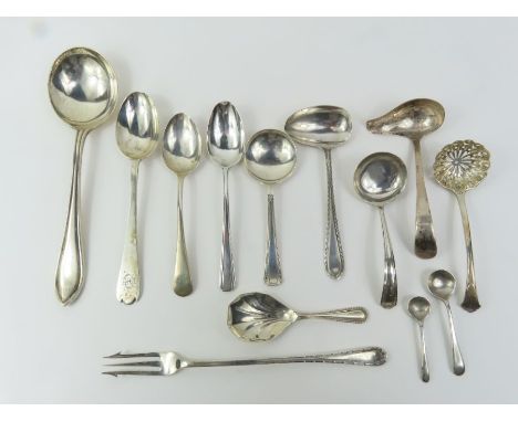 A silver pickle fork, a silver caddy spoon and various other silver spoons, 343.2g gross (11.03 Troy ounces)