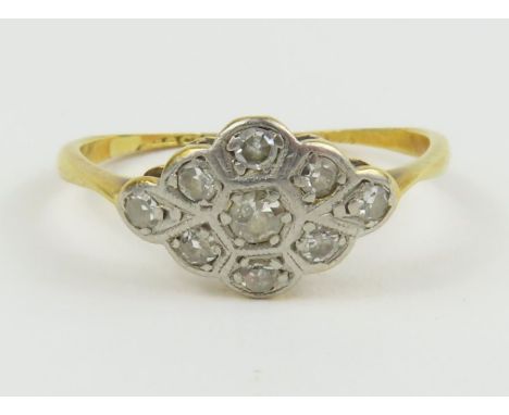 An Edwardian diamond cluster ring, in a flat setting, marked '18ct plat', finger size N, 2g gross, cased