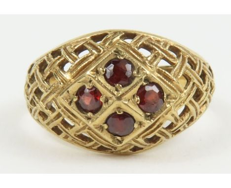 A garnet set dress ring with cut out weave head, marked '9ct', finger size M 1/2, 2.6g gross