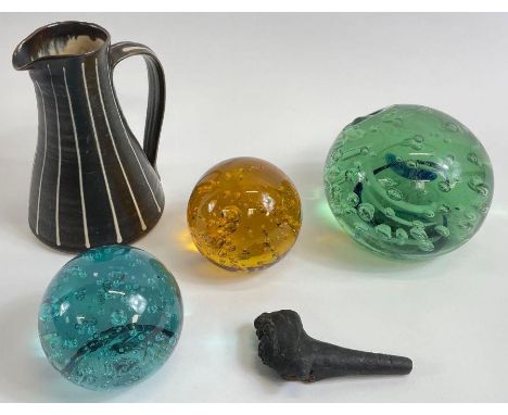 Three Victorian glass bubble paperweights, along with an Arch St Ives pottery jug and a smoking pipe 