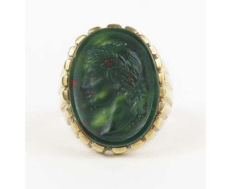 A 9ct gold signet ring set with an oval bloodstone with an intaglio of man wearing a wreath of leaves, finger size S, 6.81g g