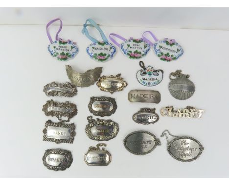 A collection of decanter labels to include silver plated and ceramic examples