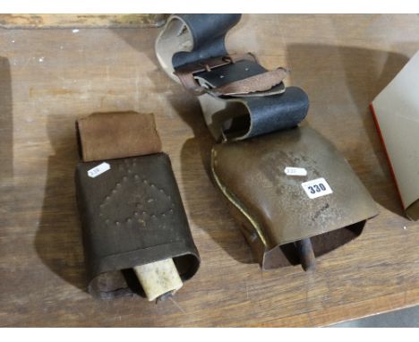     A Large Vintage European Cow Bell, Together With A Smaller Cow Bell             