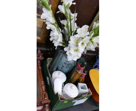 Artificial flowers in a vase, glass kitchen ornaments, ceramic storage jars and BT telephone